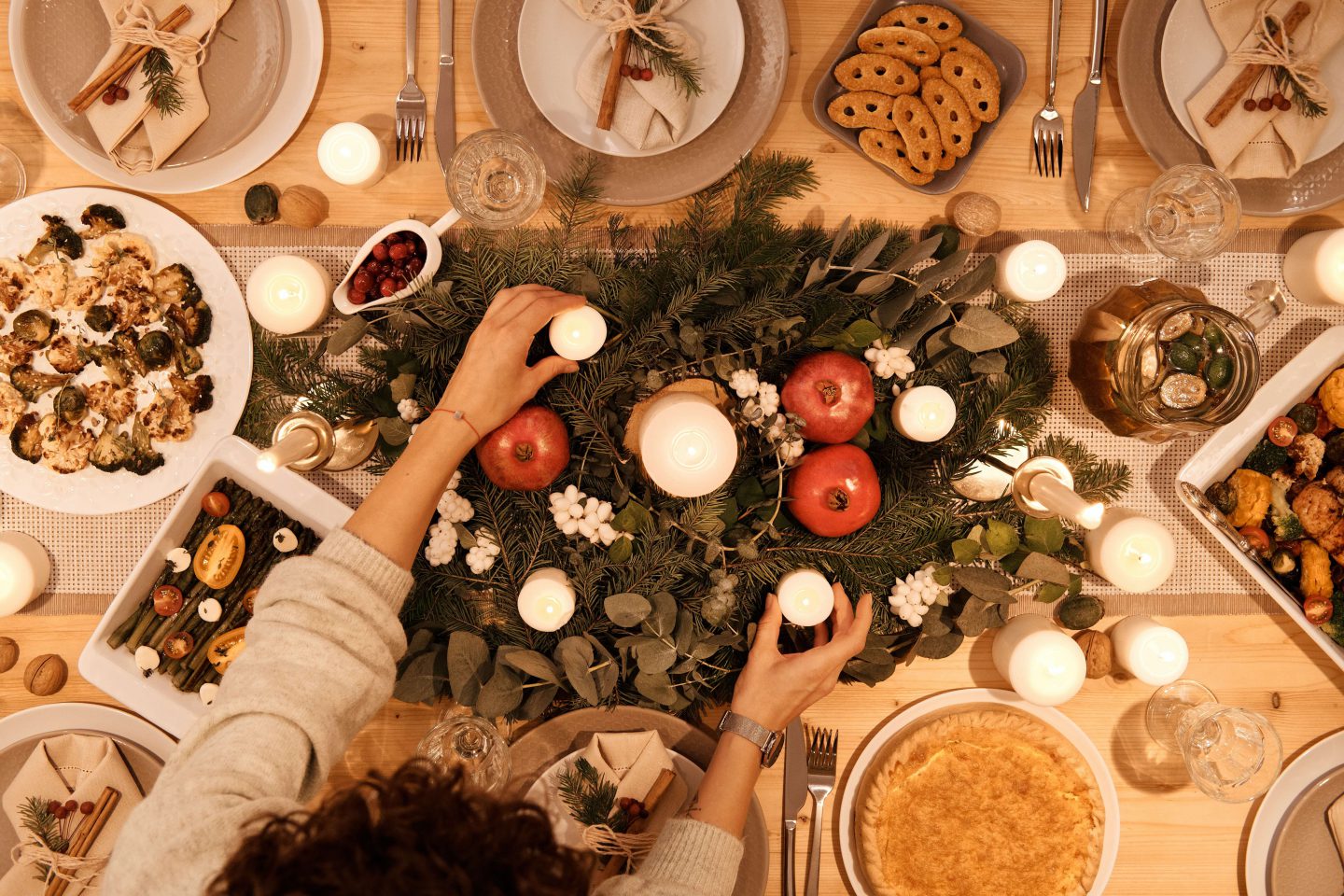 An overhead photo of a Christmas table with food and decorations