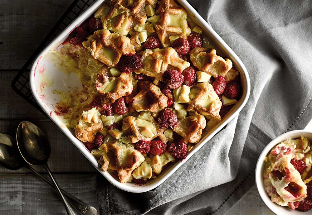 An overhead photo of a waffle and fruit bake in a big ovenproof dish