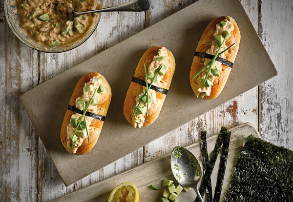 An overhead photo of three St Pierre Brioche Rolls filled with a crab and avocado mixture on a long serving plate Ideal For Valentine's Day Quiz