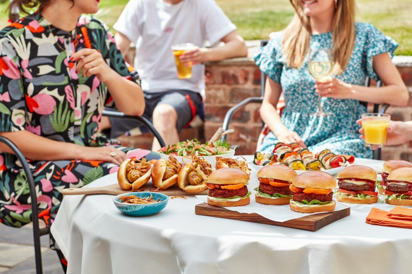 People Having an Outdoor Lunch with hot dogs and burgers